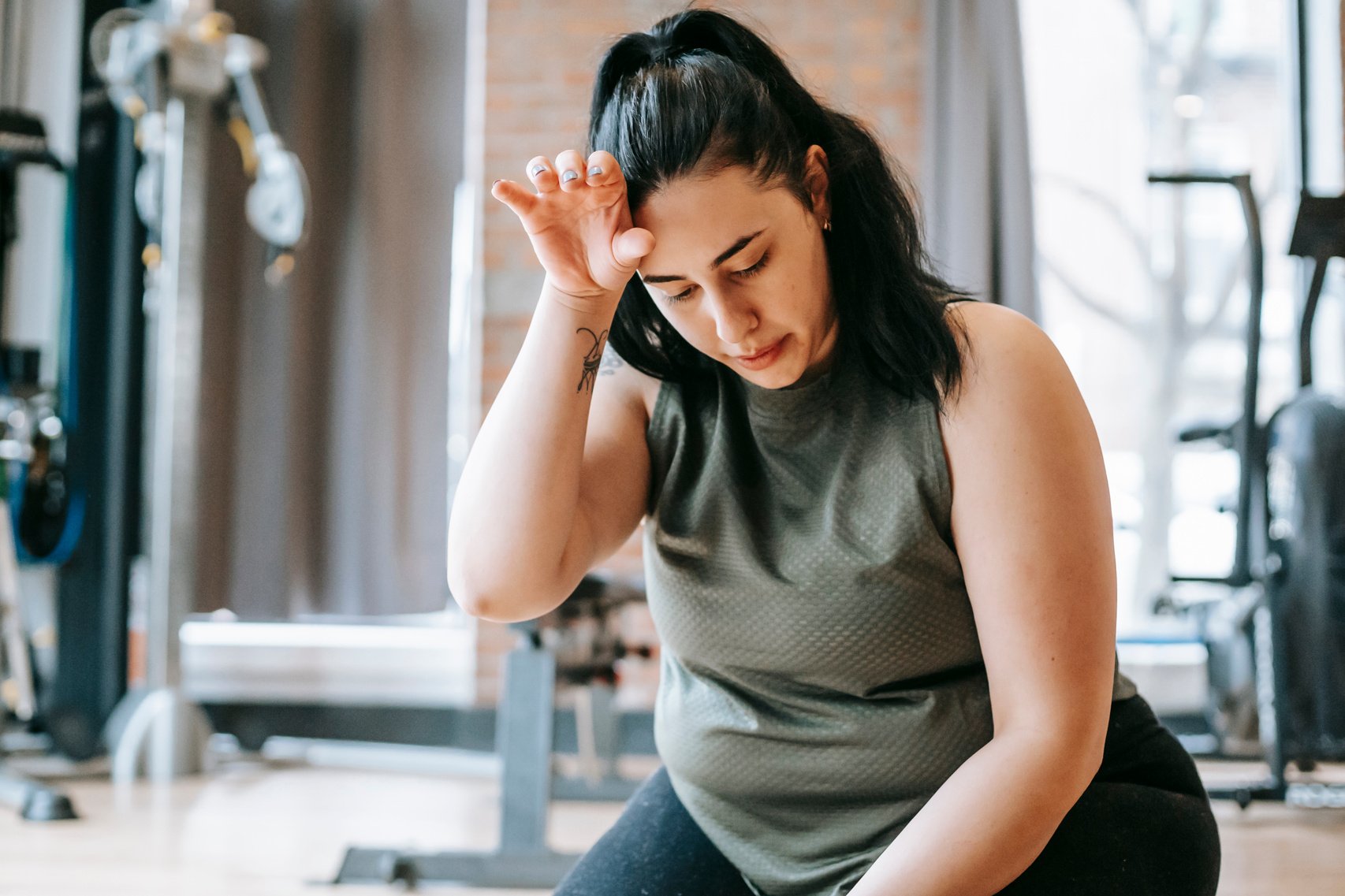 Tired female training in gym